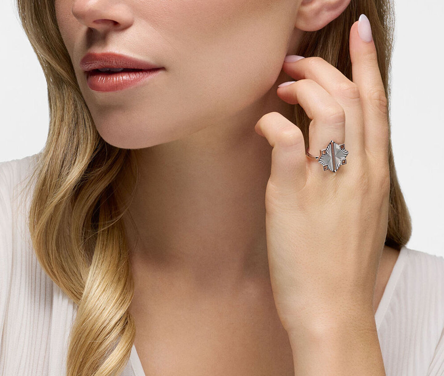 A woman wearing a Birks Muse silver ring.